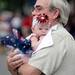 Tom Hoeg, of Northville, holds his three-month-old granddaughter Harper Johansen, of Florida, at the end of the 23rd Annual Ann Arbor Jaycees Fourth of July Parade on Thursday, July 4, 2013 on South State Street in downtown Ann Arbor. Melanie Maxwell | AnnArbor.com